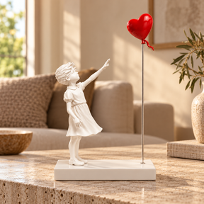 A Little Hope sculpture in white & red, displayed in a styled interior