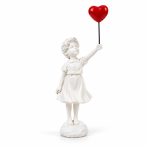 Held in Hope girl with heart balloon sculpture in white & red, on a white studio background