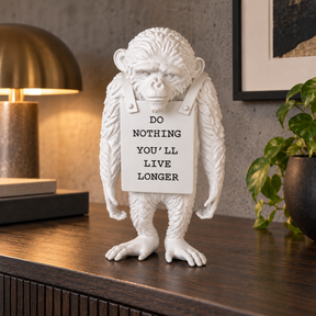 Silent Protest sculpture in all white, displayed in a styled interior