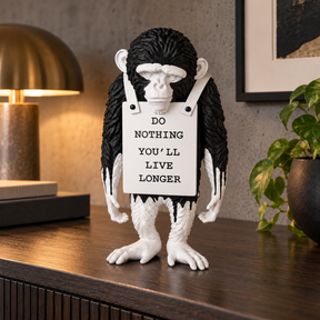 Silent Protest sculpture in black drip, displayed in a styled interior